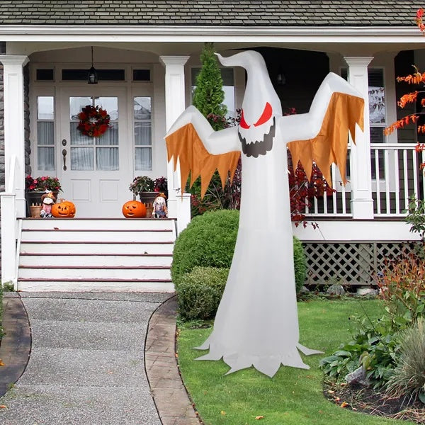 Halloween inflatable ghost decoration on a front lawn with a house in the background.