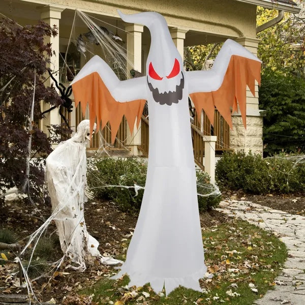 Halloween inflatable ghost decoration in front of a house with a skeleton.